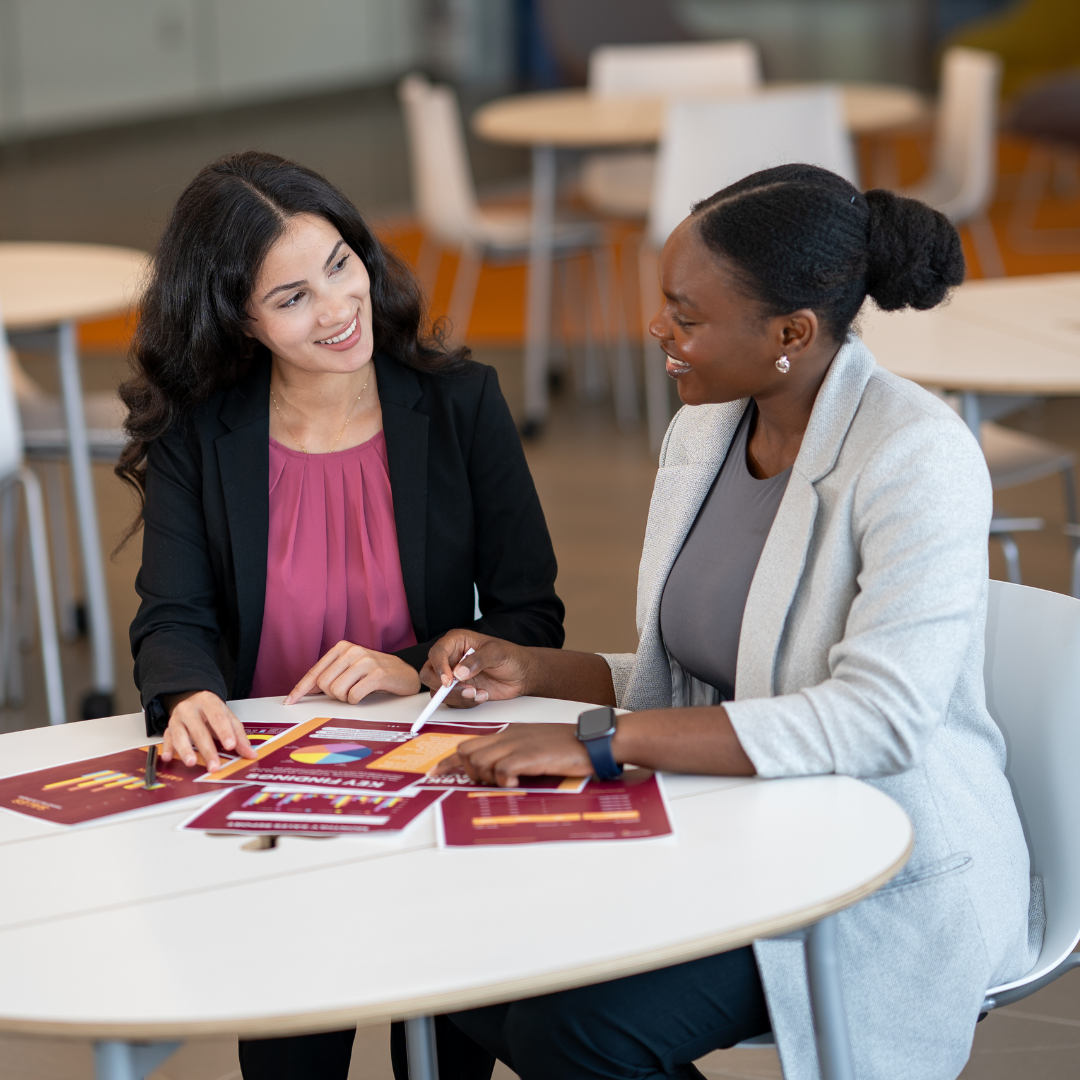 An advisor pointing to documents during a student consultation.